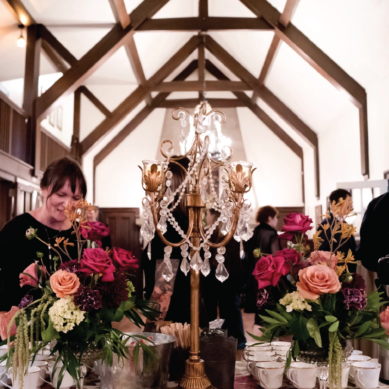 A woman looks down at floral decorations inside IntheOaks
