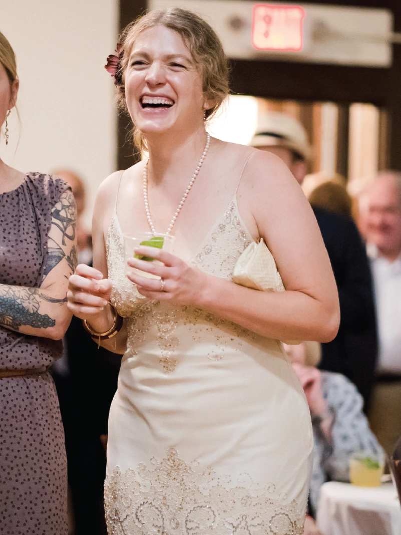 A woman in a white dress laughs